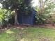 Dark blue storage shed located in the backyard at 3937 Overlook Ne Dr, St Petersburg, FL 33703