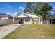 Charming single-story home with a well-maintained lawn and driveway at 4110 E Comanche Ave, Tampa, FL 33610