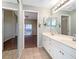 Double vanity bathroom with a view of a bedroom at 6629 Pineview Ter # 5-201, Bradenton, FL 34203