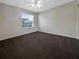 Empty bedroom with carpeted floors and large window at 6629 Pineview Ter # 5-201, Bradenton, FL 34203