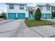 Condo building with teal garage doors and landscaping at 6629 Pineview Ter # 5-201, Bradenton, FL 34203