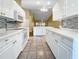 Bright white kitchen with ample counter space and stainless steel appliances at 6629 Pineview Ter # 5-201, Bradenton, FL 34203