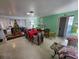 Dining room with red table and Christmas tree in the background at 1041 Porpoise Rd, Venice, FL 34293