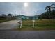 Cute teal house with a well-maintained lawn and driveway at 1041 Porpoise Rd, Venice, FL 34293