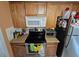 Kitchen with wood cabinets, granite countertop and built-in microwave at 1041 Porpoise Rd, Venice, FL 34293