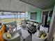 Relaxing screened porch with wicker furniture at 1041 Porpoise Rd, Venice, FL 34293