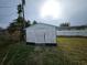 White wooden storage shed in backyard at 1041 Porpoise Rd, Venice, FL 34293