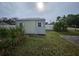 Grey storage shed with double doors at 1041 Porpoise Rd, Venice, FL 34293