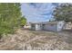 Fenced backyard with mature trees and grassy area at 11615 Meadow Dr, Port Richey, FL 34668