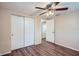 Bedroom with ceiling fan, wood-look floors, and closet at 11615 Meadow Dr, Port Richey, FL 34668