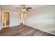 Bedroom with ceiling fan, wood-look floors, and en-suite bathroom at 11615 Meadow Dr, Port Richey, FL 34668