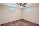 Well-lit bedroom with ceiling fan and wood-look floors at 11615 Meadow Dr, Port Richey, FL 34668