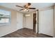 Bright bedroom with ceiling fan, wood-look floors, and ample closet space at 11615 Meadow Dr, Port Richey, FL 34668