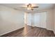Bedroom with ceiling fan, wood-look floors and access to bathroom at 11615 Meadow Dr, Port Richey, FL 34668