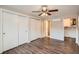 Spacious bedroom with ceiling fan, wood-look floors, and large closets at 11615 Meadow Dr, Port Richey, FL 34668