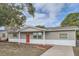 Newly renovated one-story house featuring gray exterior and red front door at 11615 Meadow Dr, Port Richey, FL 34668