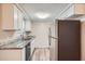 Modern kitchen with white cabinets, granite counters, and stainless steel appliances at 11615 Meadow Dr, Port Richey, FL 34668