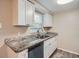 Updated kitchen featuring white cabinets, granite countertops, and stainless steel appliances at 11615 Meadow Dr, Port Richey, FL 34668