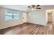 Bright living room with wood-look floors and ceiling fan at 11615 Meadow Dr, Port Richey, FL 34668