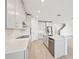 Bright kitchen featuring stainless steel appliances, a center island, and white cabinetry at 13847 Richland Gulf Cir, Parrish, FL 34219