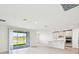 Bright open-concept living space with lake view, seamlessly integrates the kitchen and living area at 13847 Richland Gulf Cir, Parrish, FL 34219