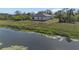 House with water view and grassy backyard at 1649 N San Mateo Dr, North Port, FL 34288