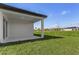 Covered patio with concrete flooring and grassy backyard at 1649 N San Mateo Dr, North Port, FL 34288