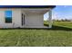Covered patio with concrete flooring and grassy backyard at 1649 N San Mateo Dr, North Port, FL 34288