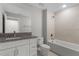 Clean bathroom with white vanity and tiled shower/tub at 1649 N San Mateo Dr, North Port, FL 34288