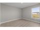 Bright bedroom with large window and neutral walls at 1649 N San Mateo Dr, North Port, FL 34288