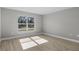 Bright bedroom featuring wood-look flooring and large window at 1649 N San Mateo Dr, North Port, FL 34288