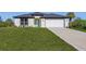 One-story home with attached garage and grassy yard at 1649 N San Mateo Dr, North Port, FL 34288