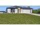 One-story house with attached garage and large lawn at 1649 N San Mateo Dr, North Port, FL 34288