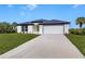 One-story home with attached garage and landscaped lawn at 1649 N San Mateo Dr, North Port, FL 34288