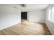Simple bedroom with wood-look flooring and access to hallway at 1490 Fundy Rd, Venice, FL 34293