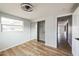 Bright bedroom with mirrored closet and wood-look flooring at 1490 Fundy Rd, Venice, FL 34293