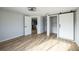Spacious bedroom with barn door closet and wood flooring at 1490 Fundy Rd, Venice, FL 34293