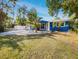 Cute blue house with a landscaped yard and palm trees at 4430 Huntington Ne St, St Petersburg, FL 33703