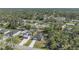 An aerial view shows the house nestled in a lush, green neighborhood with mature trees at 4495 Eldron Ave, North Port, FL 34286