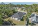 Aerial shot of the back of the home, showing the lush green backyard and wood privacy fence at 4495 Eldron Ave, North Port, FL 34286