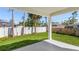 A covered outdoor living space overlooks a well-maintained lawn and white privacy fence at 4495 Eldron Ave, North Port, FL 34286