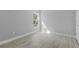Bright bedroom featuring wood-look flooring, natural light and light gray painted walls at 4495 Eldron Ave, North Port, FL 34286