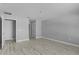 Empty bedroom with wood-look flooring and multiple doors leading to other areas at 4495 Eldron Ave, North Port, FL 34286