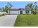 Inviting single-story home featuring a manicured lawn and a modern, two-car garage at 4495 Eldron Ave, North Port, FL 34286