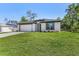 Charming single-story home with a lush green lawn and a convenient two-car garage at 4495 Eldron Ave, North Port, FL 34286