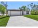 Well-maintained single-story home with a spacious driveway and an attached two-car garage at 4495 Eldron Ave, North Port, FL 34286