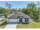 Charming single-story home featuring a two-car garage, dark roof, and a well-manicured front lawn at 4495 Eldron Ave, North Port, FL 34286