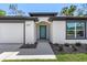 Contemporary single-story home featuring a welcoming entrance and a convenient two-car garage at 4495 Eldron Ave, North Port, FL 34286