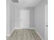 Bright foyer with wood-look flooring and a classic white entry door at 4495 Eldron Ave, North Port, FL 34286