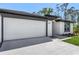 Close-up of a two-car garage with a modern design and well-kept landscaping at 4495 Eldron Ave, North Port, FL 34286